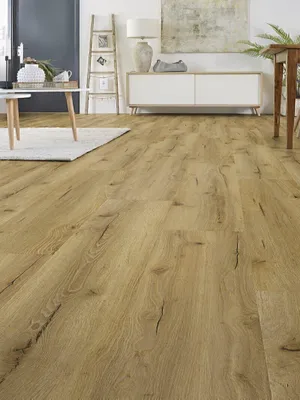 A room with wooden flooring, a white cabinet, a ladder shelf, and a coffee table.