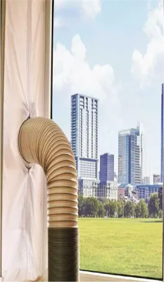 A flexible hose for a portable air conditioner is installed in a window, with a city skyline visible in the background.