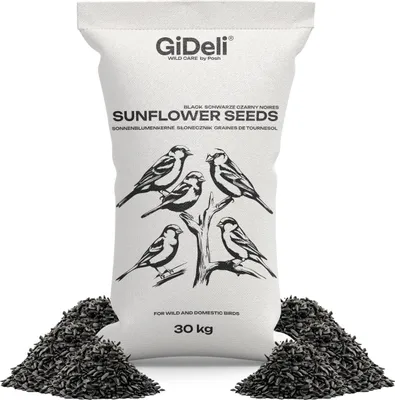 A bag of sunflower seeds for wild and domestic birds, with a depiction of birds on the bag and piles of seeds at the base.