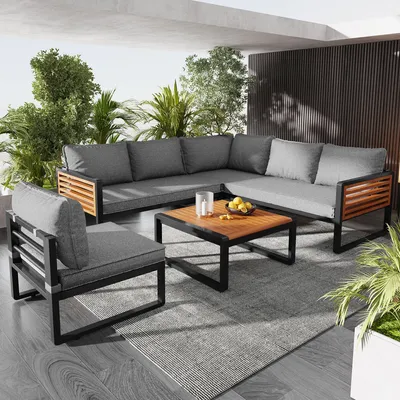 An outdoor lounge set on a patio with plants.