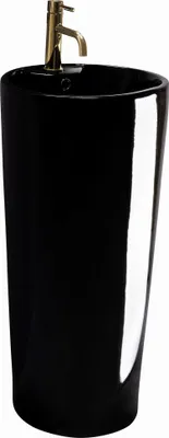 A black pedestal sink with a gold faucet.