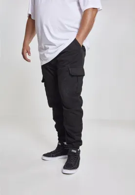 A person wearing black cargo jogging pants and a white t-shirt, standing against a white background.