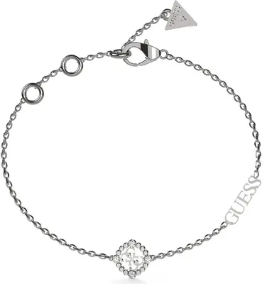 A silver Guess bracelet with a diamond-shaped charm featuring the Guess logo and small stones, and the word 'GUESS' written along the chain.