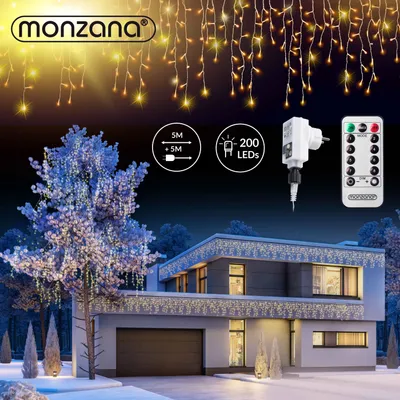 A house decorated with icicle lights at night, with a tree also illuminated by lights.