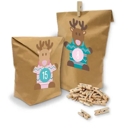 Two brown paper bags decorated with reindeer stickers and clothespins scattered in front.