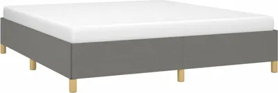 A boxspring bed frame with a white mattress on top, shown from a slightly elevated side angle against a white background.