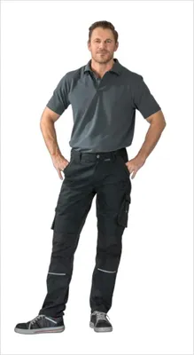 A man wearing black work pants and a gray polo shirt, posing with his hands on his hips.