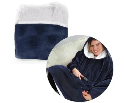 A folded blanket with sleeves and a hoodie, and a woman wearing the blanket on a couch.
