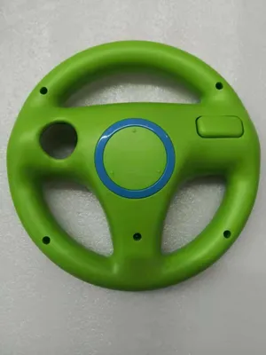 A green steering wheel controller for the Nintendo Wii.