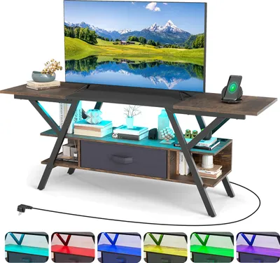 A TV stand with a television on top, featuring LED lighting and a wireless charging pad for a phone.