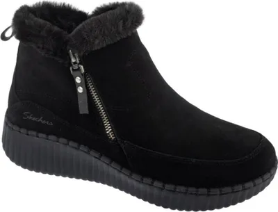 A black Skechers boot with a zipper and faux fur trim is shown against a white background.