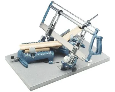 A miter saw with wood pieces attached, set against a white background.