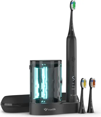 A black electric toothbrush and its accessories are displayed on a white background.