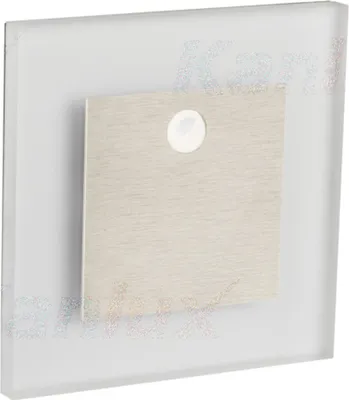 A square, frosted glass panel with a brushed metal square inset in the center. The metal inset has a small circular white element in its upper center.