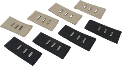Several fabric extensions with metal pins for adjusting waistband size.