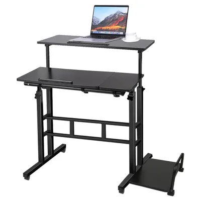 A black adjustable height computer desk with a laptop on the top shelf and a cup of coffee.