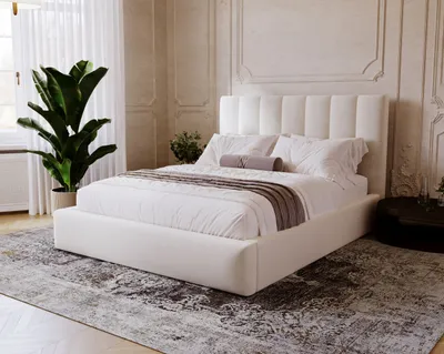 A bedroom scene with a white bed, large plant, and decorative wall.