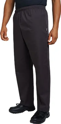 A person wearing black pants and shoes, shown from the side.