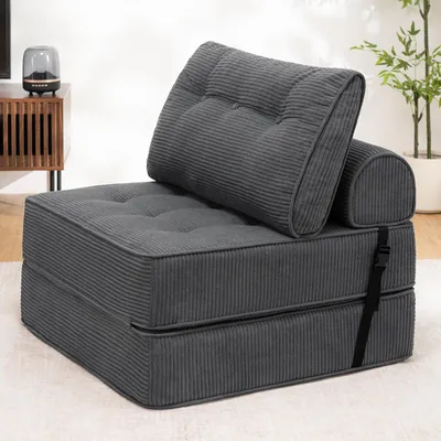 A dark gray foldable sofa bed with cushions is shown in a room.