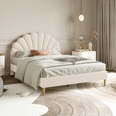 A bedroom scene featuring a bed with a shell-shaped headboard.