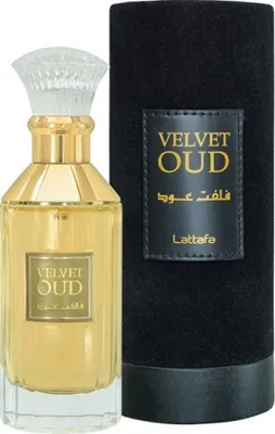 A bottle of Lattafa Velvet Oud Eau de Parfum and its cylindrical packaging.