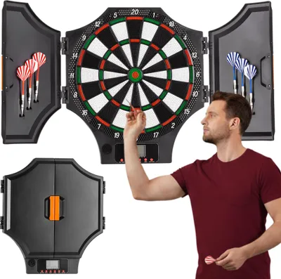A man is playing darts with an electronic dartboard that is open and mounted on a wall. The dartboard has a digital display and is surrounded by storage compartments for darts.