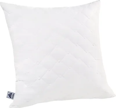 A white quilted pillow on a white background.