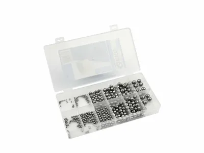 A clear, well-lit studio shot of a transparent plastic organizer box filled with various sizes of metal ball bearings, set against a plain white background.