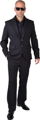 A man wearing a black suit, shirt, and tie, with sunglasses.