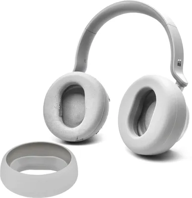 A pair of gray headphones and a separate accessory are shown against a white background.