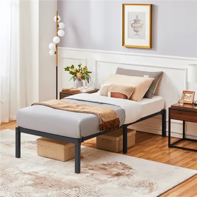A bedroom scene featuring a single bed with bedding and decorative items.