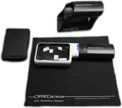 A set of optical tools including a magnifying glass, a protective case, and a cleaning cloth, laid out on a black surface.