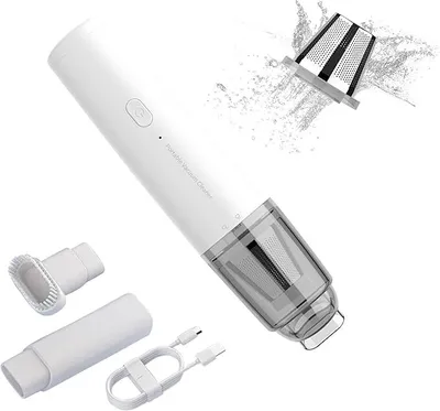 A white portable vacuum cleaner with accessories and a charging cable, shown against a white background. A graphic element shows a filter being cleaned with water.