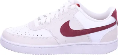 A side view of a white and beige Nike Court Vision Low sneaker with a red Nike swoosh.