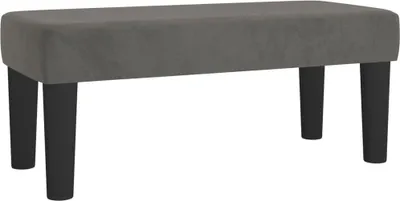 A studio shot of a dark gray velvet bench with black legs against a white background.