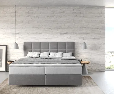 A modern bedroom with a large boxspring bed.