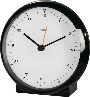 A close-up studio shot of a black alarm clock with a white face and black hands.