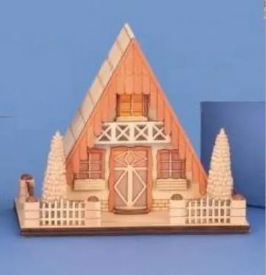 Das Bild zeigt ein kleines detailliertes Holzmodell eines A-förmigen Hauses mit Balkon und Vorgarten