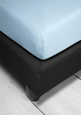 A close-up view of a light blue fitted sheet on a black bed base.