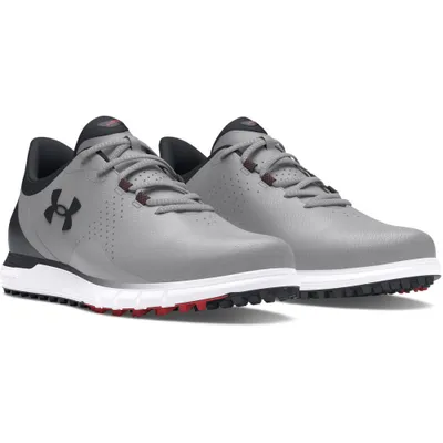 A pair of grey Under Armour golf shoes are shown against a white background.