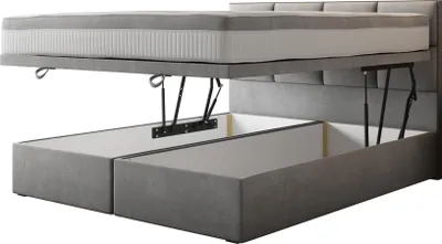 A bed frame with a mattress lifted to reveal storage compartments underneath.
