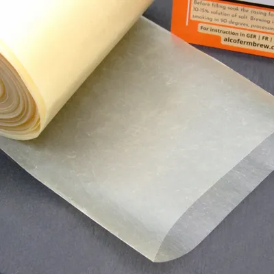 A roll of casing material, likely for sausages, is shown partially unrolled.