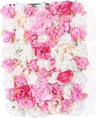 A close-up view of a wall of artificial flowers in various shades of pink and white.