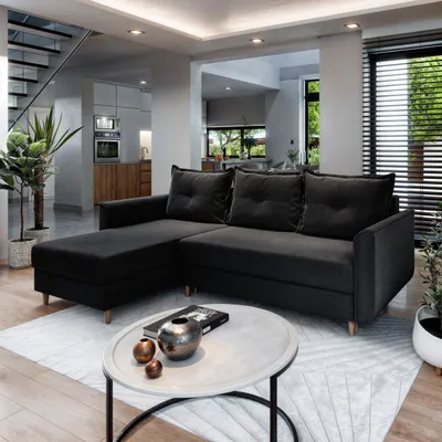 A modern living room with a sectional sofa, coffee table, and stairs.