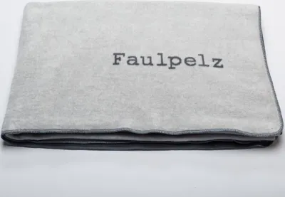 A folded gray blanket with the word 'Faulpelz' embroidered on it, placed on a white background.
