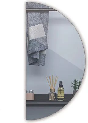 A bathroom shelf with decorative items reflected in a mirror.