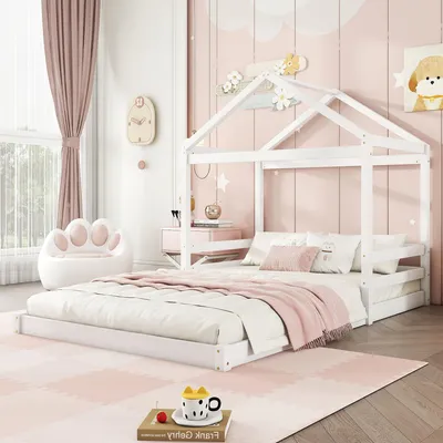 A child's bedroom with a white house-shaped bed, pink curtains, and a paw-shaped chair.