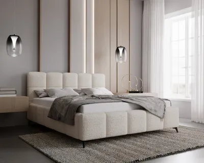 A modern bedroom with a large bed, bedside table, and decorative lighting.