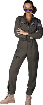 A woman wearing a pilot jumpsuit and sunglasses, posing with her arms crossed.