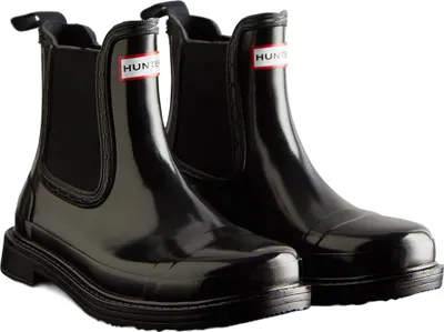 A pair of black glossy Chelsea boots with a thick sole, presented against a white background.